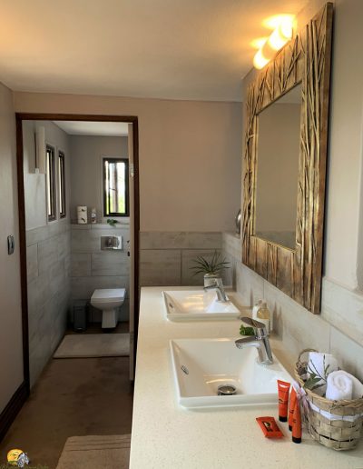 Luxury Bush Villa bathroom and double-sink wash up area